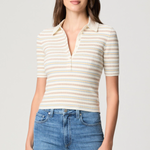 Model wearing a white printed blouse with colorful accents and short sleeves.