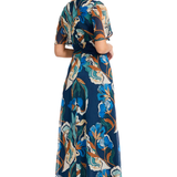 Model wearing a blue printed short-sleeve midi dress featuring a flattering waist and flowing skirt.
