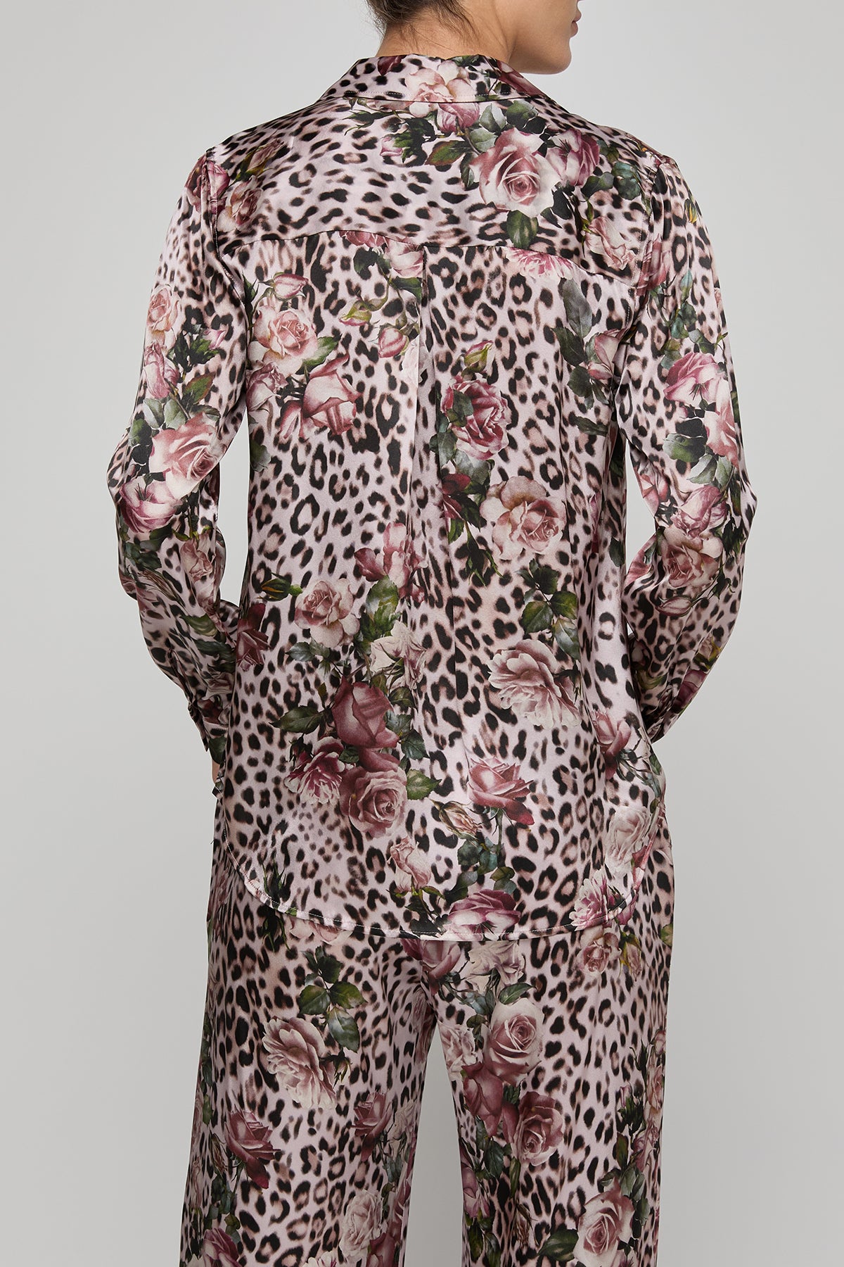 Leopard print suit with floral patterns on a plain background