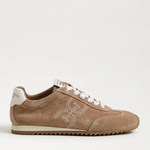 Beige sneaker with white laces on a light beige background