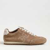 Beige sneaker with white laces on a light beige background