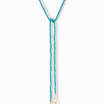 Teal beaded necklace with gold accents on a white background