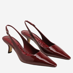 A pair of glossy burgundy patent leather slingback kitten heels with pointed toes, displayed on a light gray background.