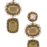 A pair of drop earrings with antique gold-toned metalwork, featuring a round pale pink stone at the top, a rectangular clear crystal halo in the middle, and a larger rectangular olive-green faceted stone at the bottom, shown on a plain white background.