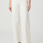 Person wearing white pants on a plain background