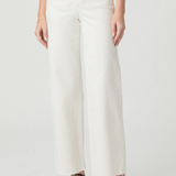 Person wearing white pants on a plain background