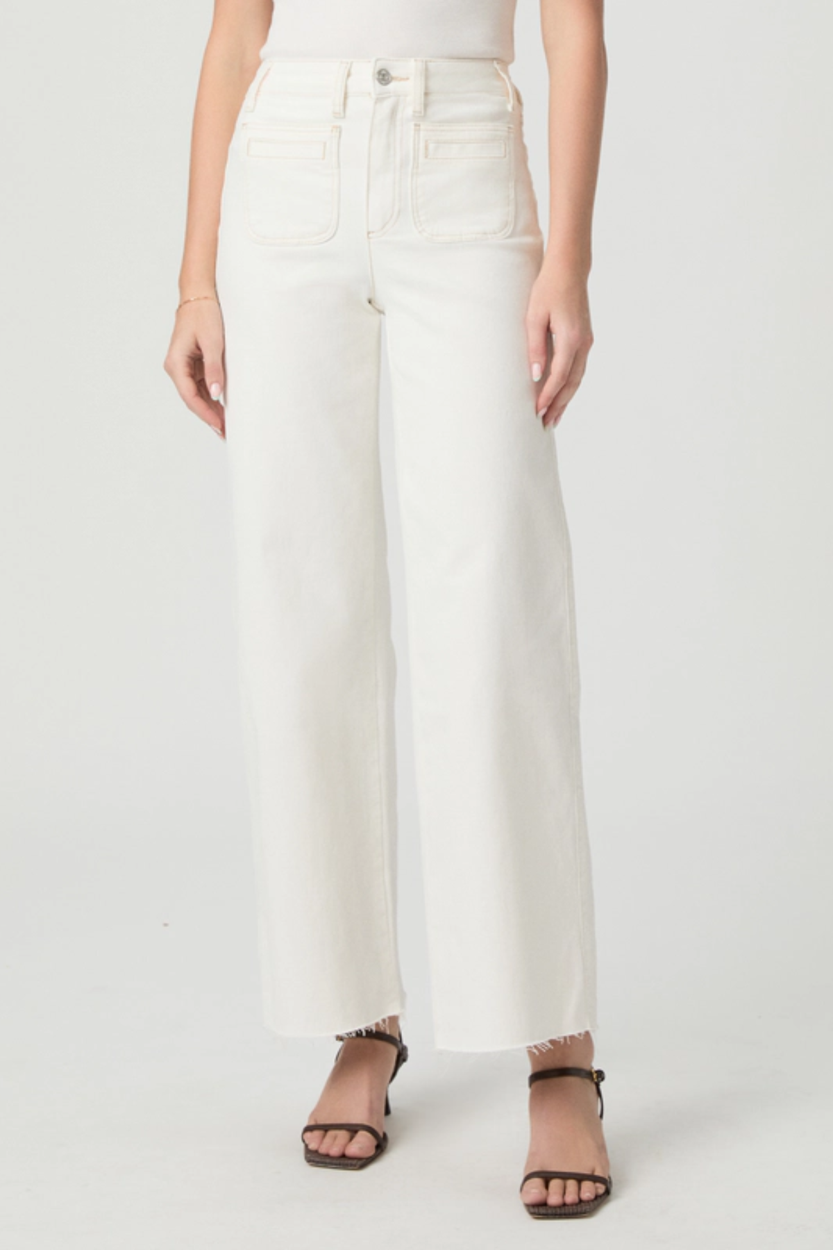 Person wearing white pants on a plain background