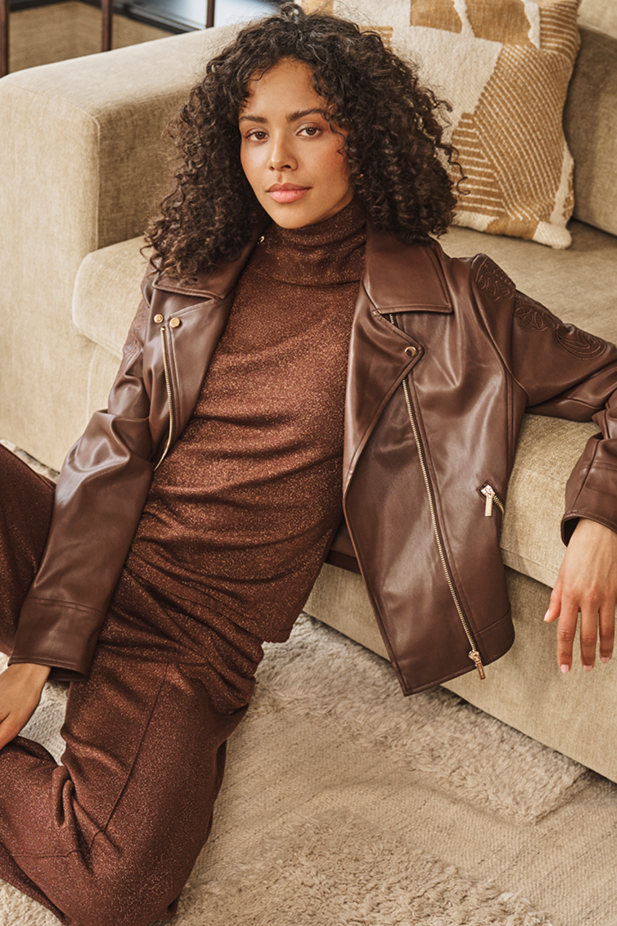 Women's brown biker-style jacket featuring embroidered detailing, long sleeves, and a structured silhouette.