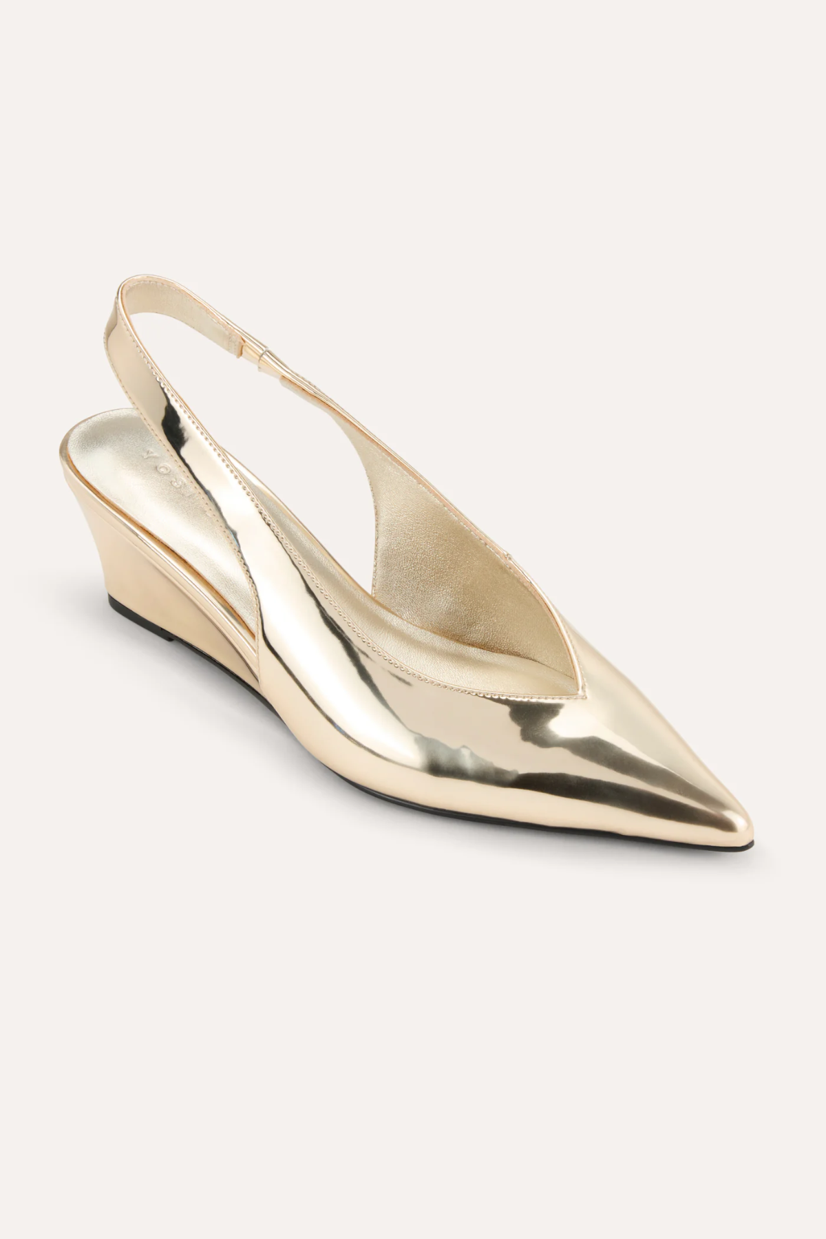 Gold metallic slingback shoe on a white background