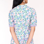 Woman wearing a floral dress with a white background