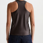 Person wearing a brown tank top and dark jeans on a white background