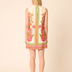 Woman wearing a floral dress with a beige background