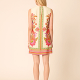 Woman wearing a floral dress with a beige background