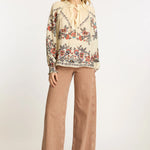 Neutral blouse with a streamlined, polished silhouette.