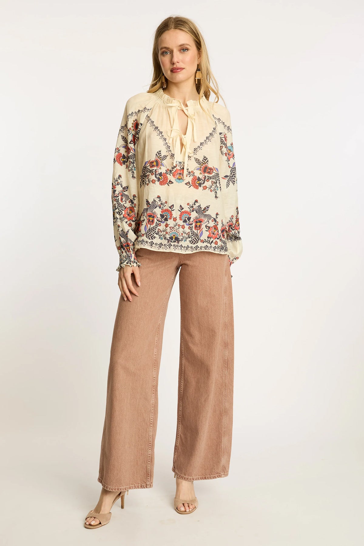 Neutral blouse with a streamlined, polished silhouette.