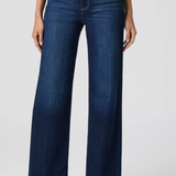 Person wearing dark blue jeans on a white background