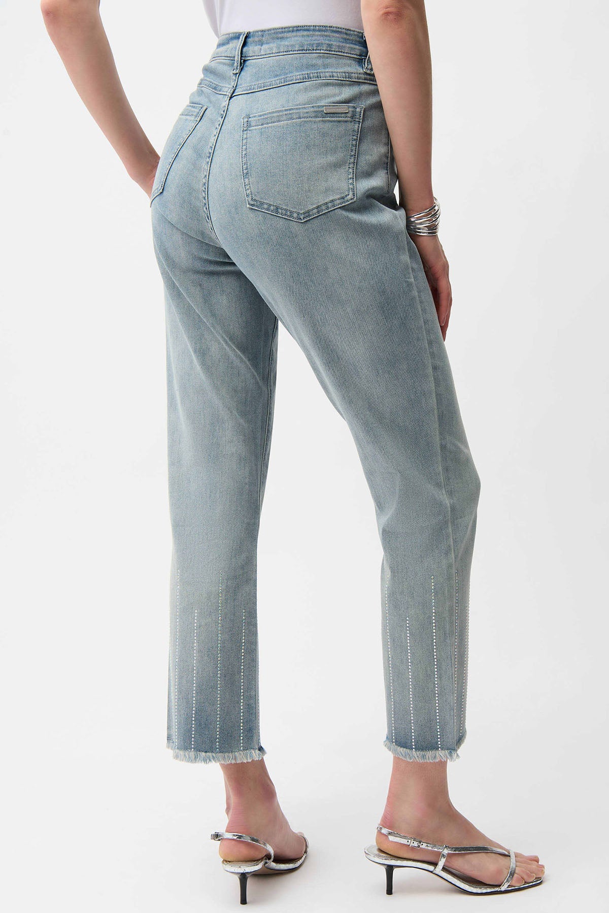 Light blue jeans worn by a person on a white background
