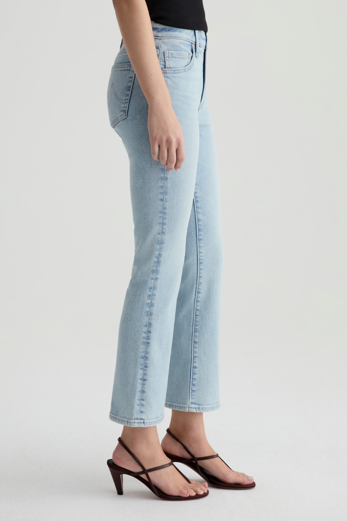 Light blue jeans worn by a person on a white background