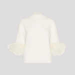 An off-white knit mock-neck sweater with three-quarter sleeves featuring fluffy feathered cuffs, displayed on a neutral light gray background.