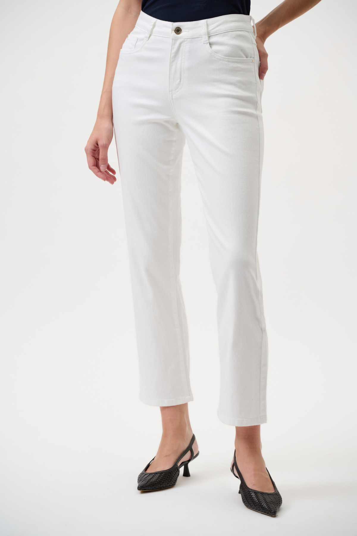Person wearing white pants on a plain background