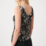 Woman wearing a leopard print sleeveless top on a white background