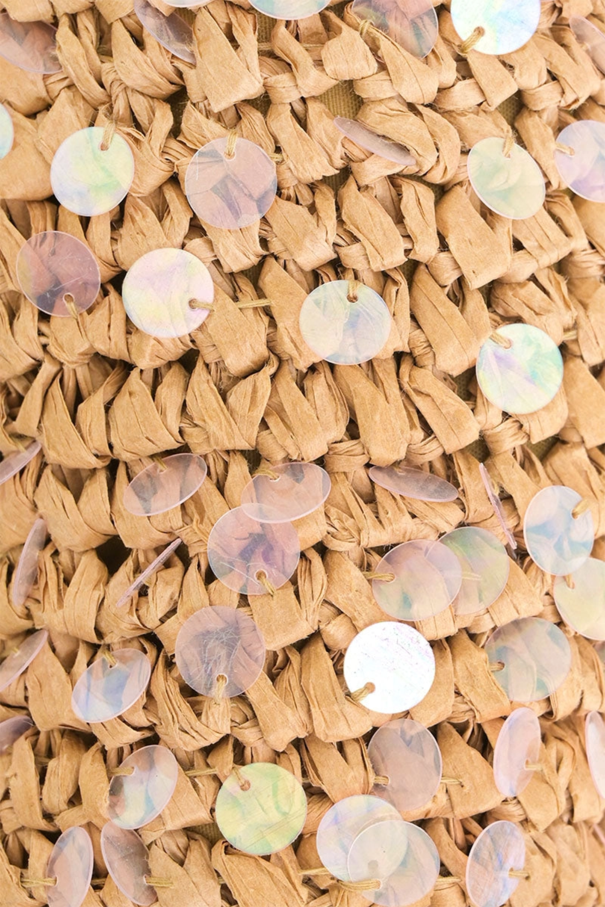 Close-up of woven material with embedded round, multicolored sequins.