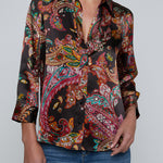 Person wearing l'agence  patterned shirt and jeans on a gray background