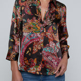 Person wearing l'agence  patterned shirt and jeans on a gray background