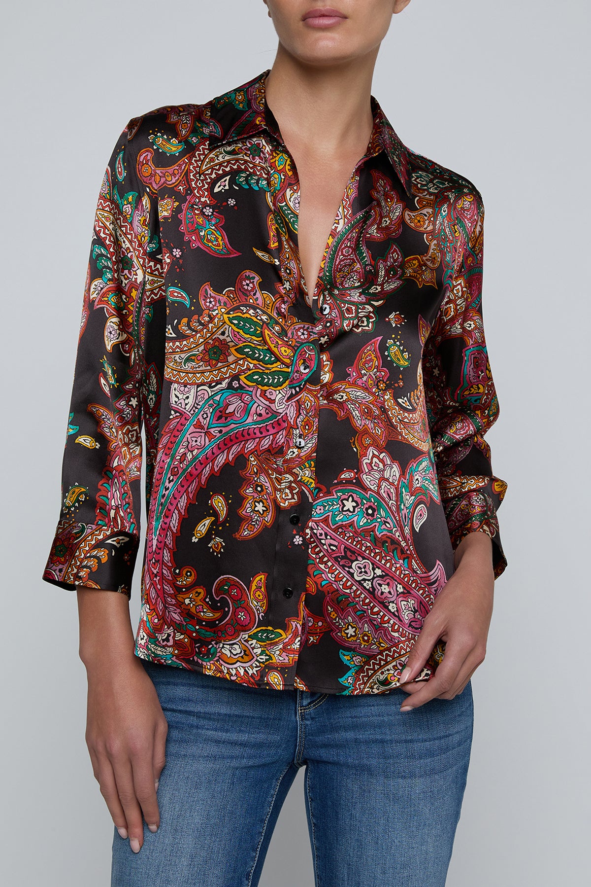 Person wearing l'agence  patterned shirt and jeans on a gray background