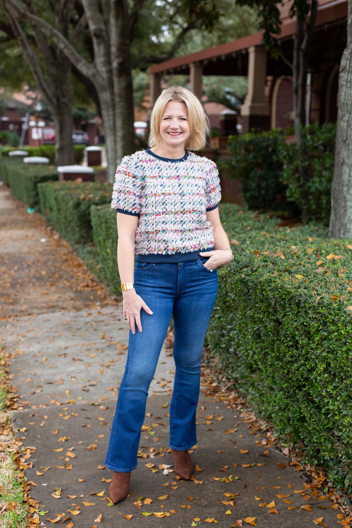 Tweed top with a structured silhouette in neutral tones.