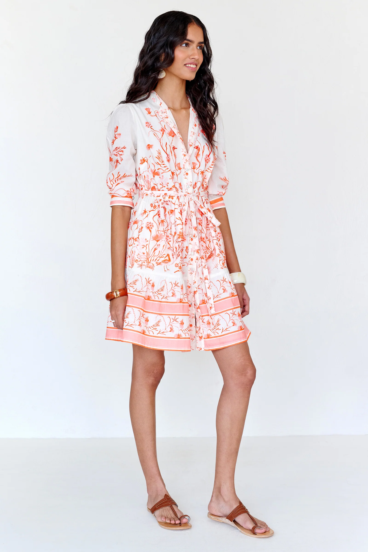 Woman wearing a floral dress on a white background