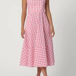 Woman wearing a pink and white checkered dress on a white background