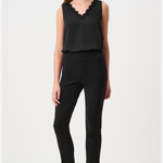 A woman modeling a black sleeveless top with a scalloped V-neckline and black cropped pants, paired with pointed-toe heeled sandals, against a plain light gray studio background.