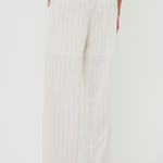 White wide-leg pants worn by a person on a white background