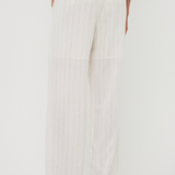 White wide-leg pants worn by a person on a white background