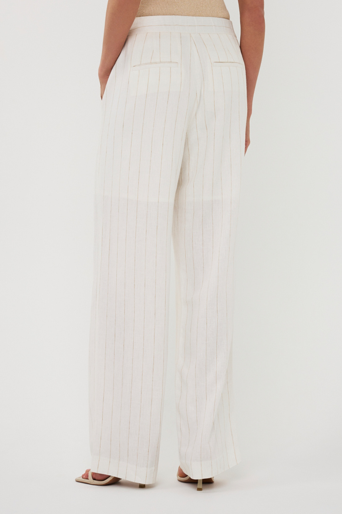 White wide-leg pants worn by a person on a white background