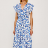 Woman wearing a blue floral dress on a white background