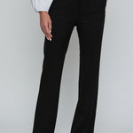 Black wide-leg pants worn with a white shirt on a plain background