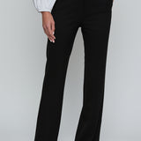 Black wide-leg pants worn with a white shirt on a plain background