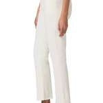 A model shown from the waist down wearing off-white cropped trousers with a frayed hem, paired with tan suede loafers against a plain white background.