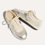 Pair of silver and cream sneakers on a white background