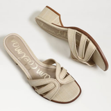 Pair of beige sandals with brown soles on a white background