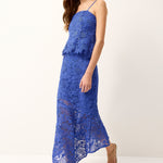 Woman wearing a blue lace dress on a white background