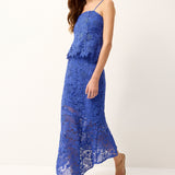 Woman wearing a blue lace dress on a white background