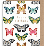 A square birthday card with a white background printed with multiple colorful butterfly illustrations and the words 'happy birthday' in the center, shown with a brown kraft envelope behind it on a white background.
