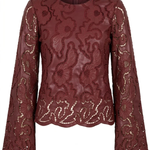 A burgundy long-sleeve blouse with an intricate floral lace overlay and scalloped edges, shown against a plain white background.