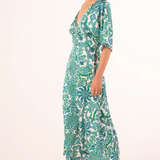 Woman wearing a green and white patterned dress on a white background