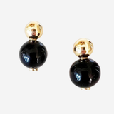 Black and gold earrings on a white background