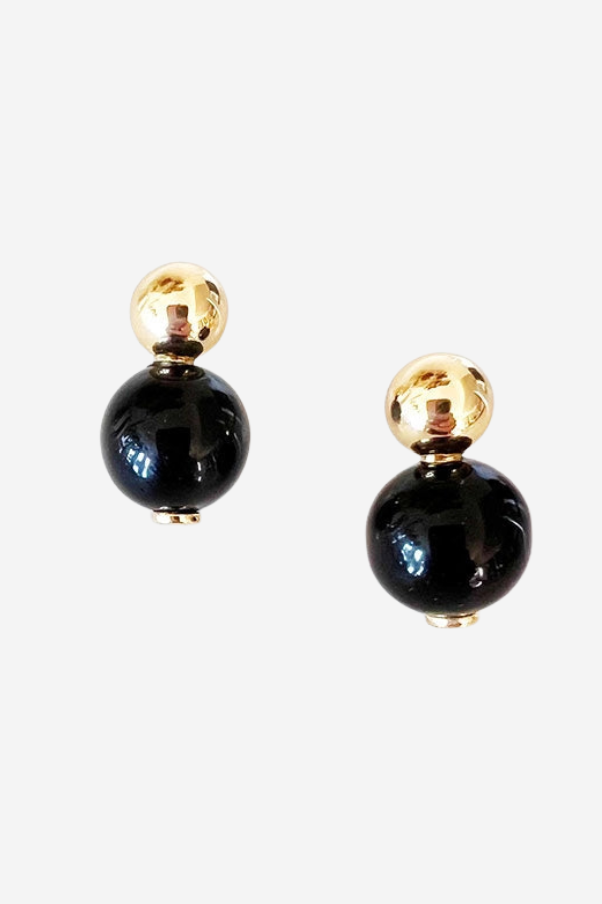 Black and gold earrings on a white background
