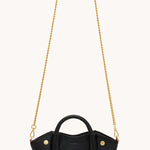 Black Hammitt Paul Mini crossbody bag worn with an evening outfit.